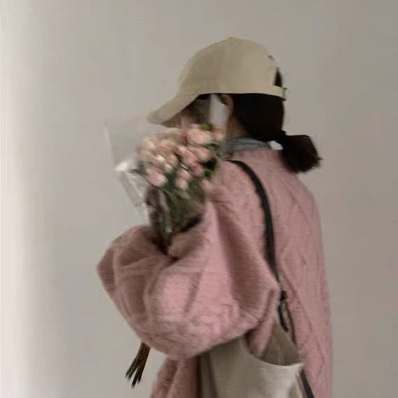 Women Wearing Loose Sweaters Outside The Street With Gentle Wind